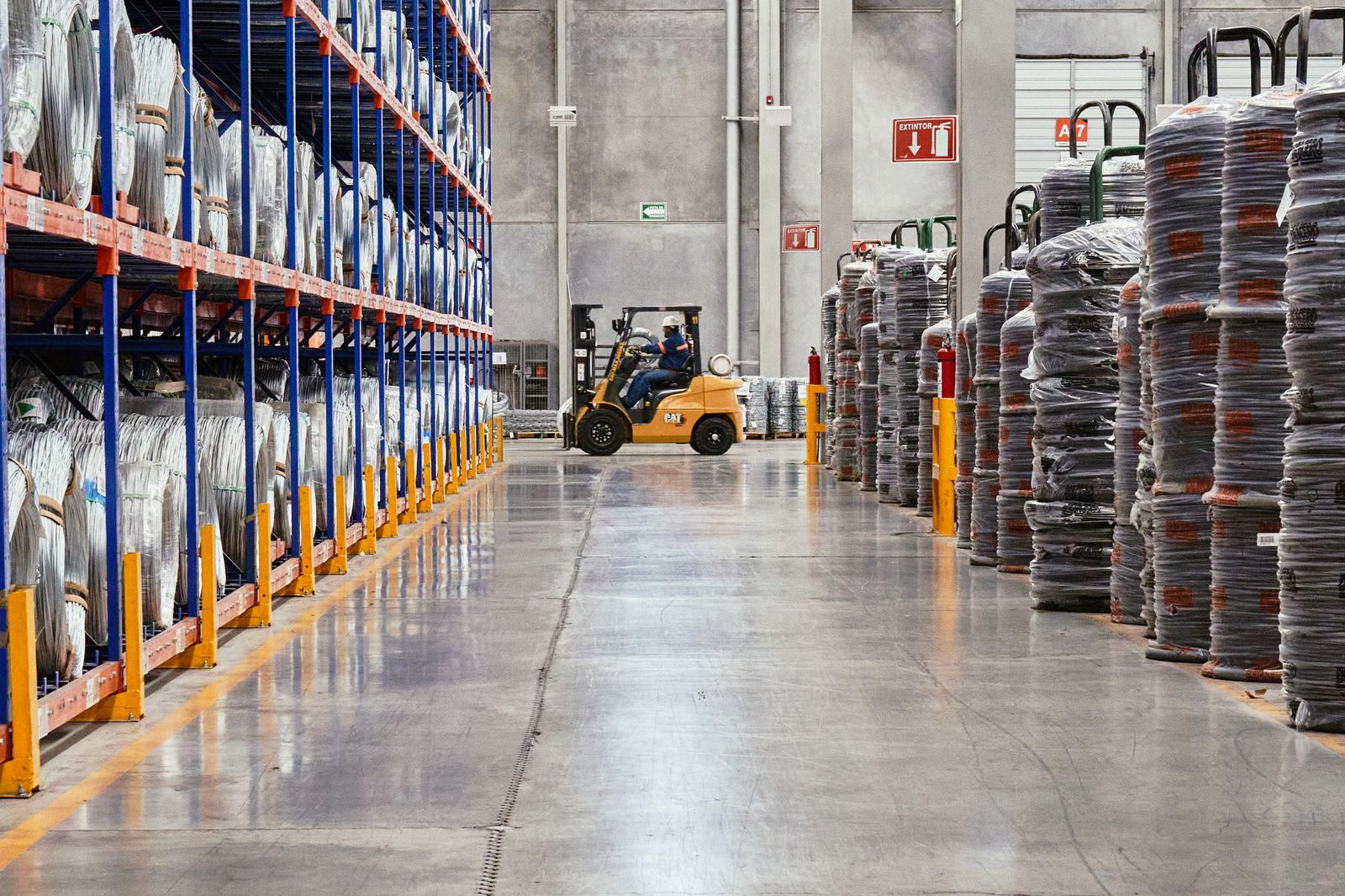 Forklift moving pallets in an industrial warehouse