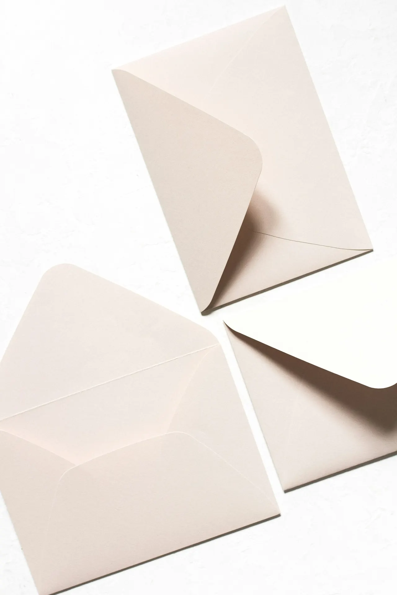 Open envelopes on a desk, ready to send