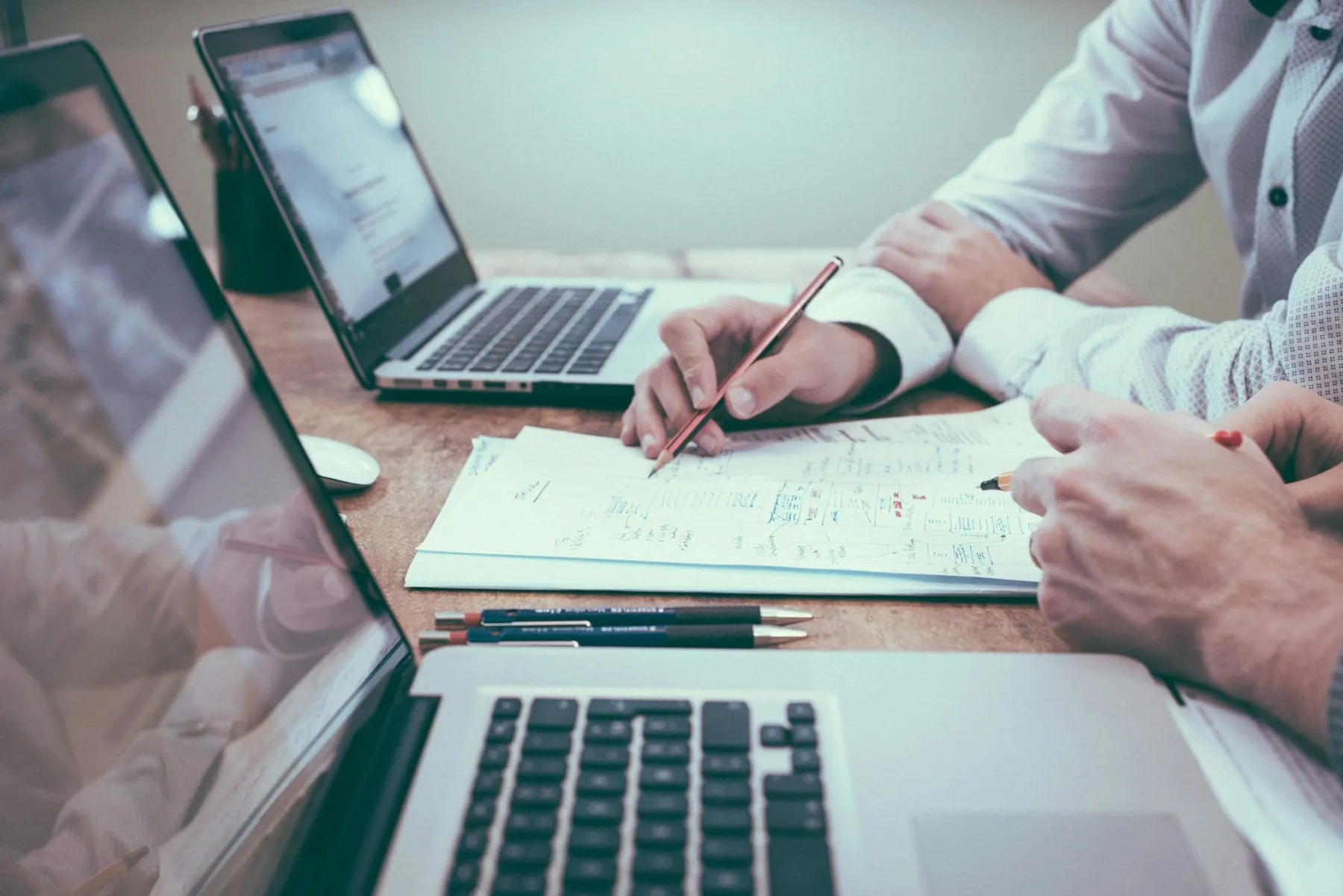Colleagues reviewing figures and diagrams at a desk